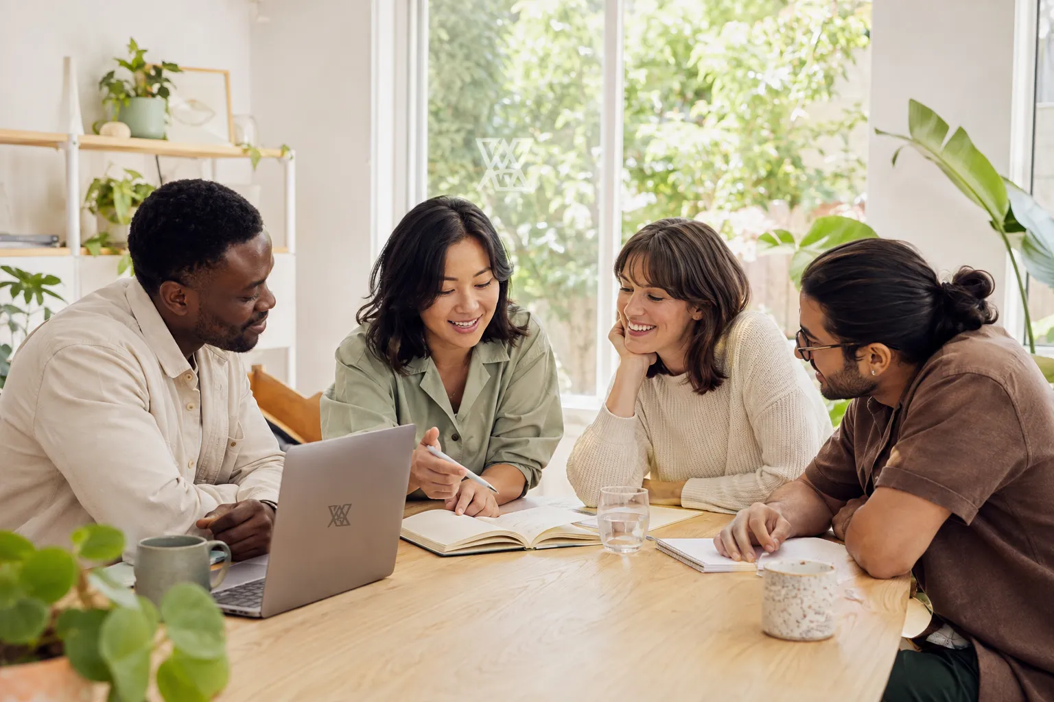 An imagined scene of colleagues listening, sharing ideas and helping one another in a welcoming workspace.
